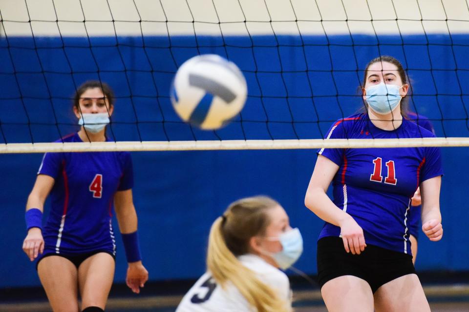 New Hartford's CeCe Dillion (11) fires a kill by Whitesboro's Olivia McArthur (5) during the volleyball game on Wednesday night. New Hartford won 3-1.