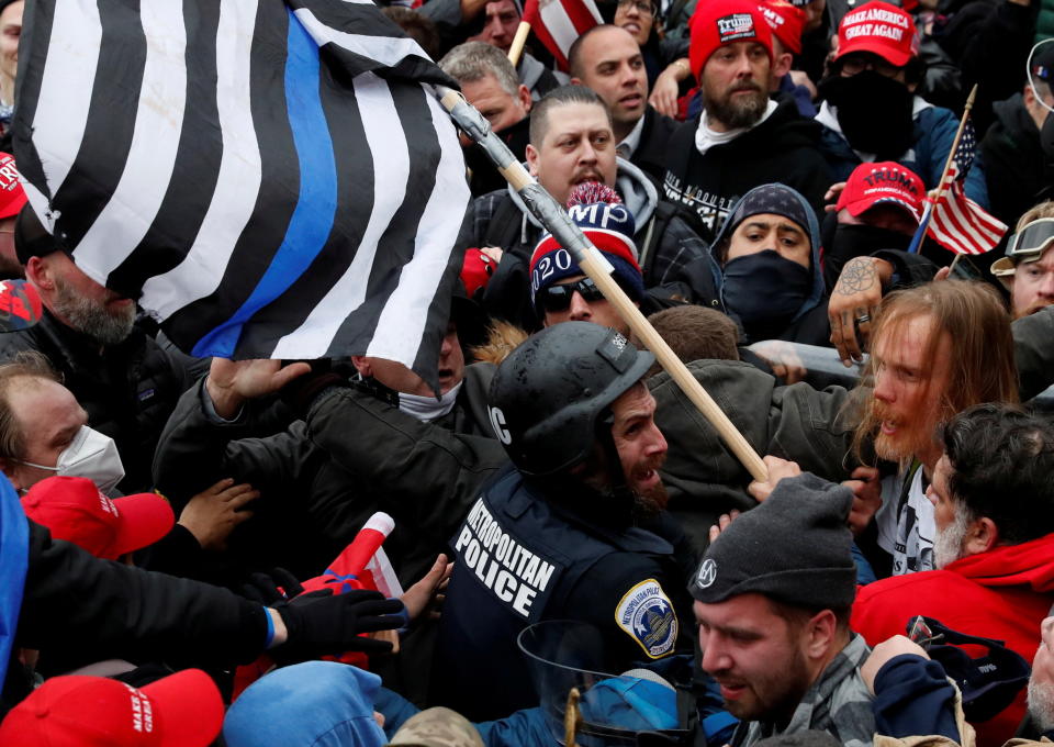 Pro-Trump protesters clash with D.C. police officer Michael Fanone at a rally to contest the certification of the 2020 presidential election results by Congress on Jan. 6. (Photo: Shannon Stapleton/Reuters)