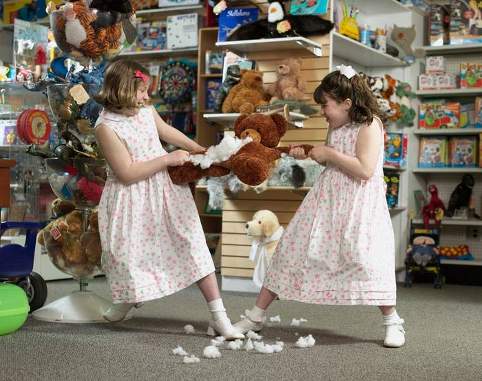 Girls fighting over stuffed bear in a toy store