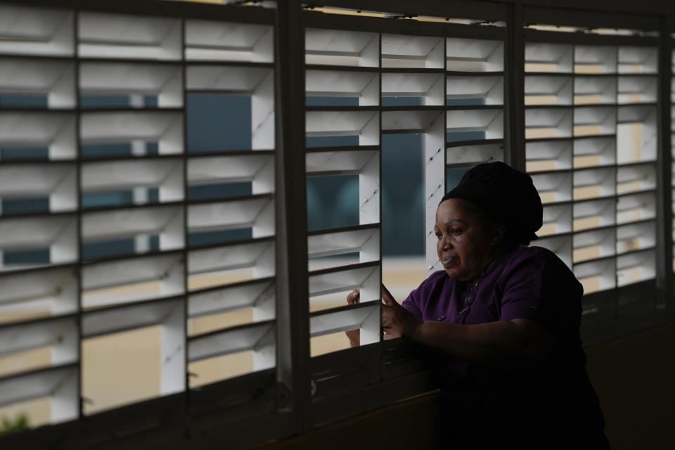 Donna Charles, a hotel cook, watches as Hurricane Beryl passes through Bridgetown, Barbados, Monday, July 1, 2024. (AP Photo/Ricardo Mazalan)