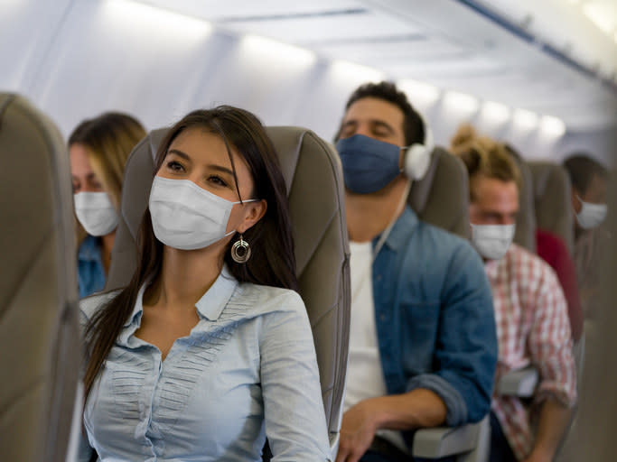 People wearing face masks on a flight