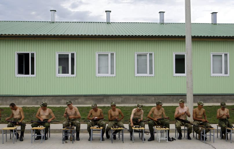 Russian soldiers clean their rifles at the military base in Tskhinvali, regional capital of Georgia's occupied province of South Ossetia, August 2009