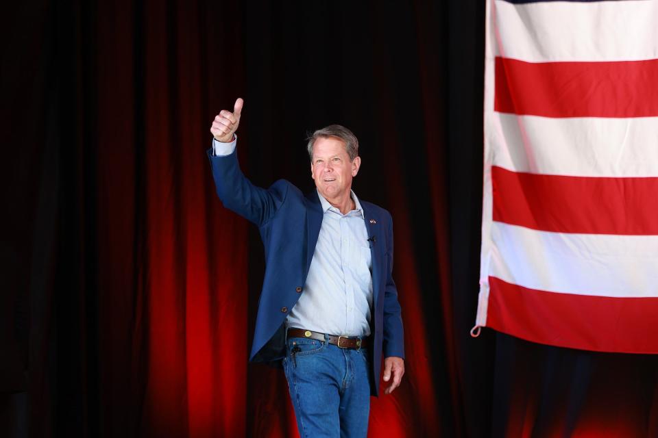 Georgia Gov. Brian Kemp gives the crowd a thumbs up as he walks onstage for a campaign rally headlined by former US Vice President Mike Pence at the Cobb County International Airport on May 23, 2022 in Kennesaw, Georgia.