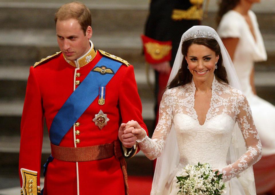 Britain's Prince William holds the hand of his wife Kate, Duchess of Cambridge as they leave Westminster Abbey after their wedding service, on April 29, 2011 in London.  AFP PHOTO/ POOL/Dave Thompson (Photo credit should read Dave Thompson/AFP via Getty Images)