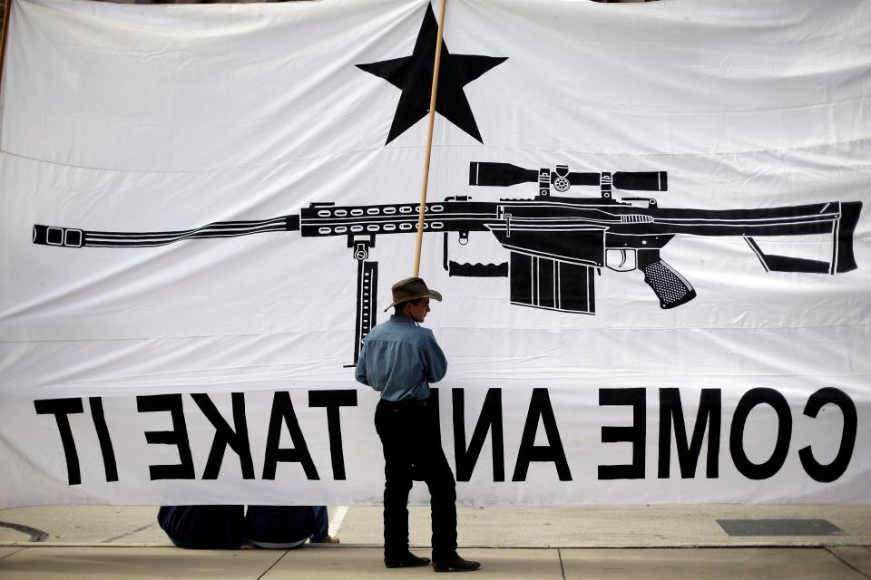 Austin Ehlinger helps hold a banner during a Guns Across America rally at the state capitol, Saturday, Jan. 19, 2013, in Austin, Texas.