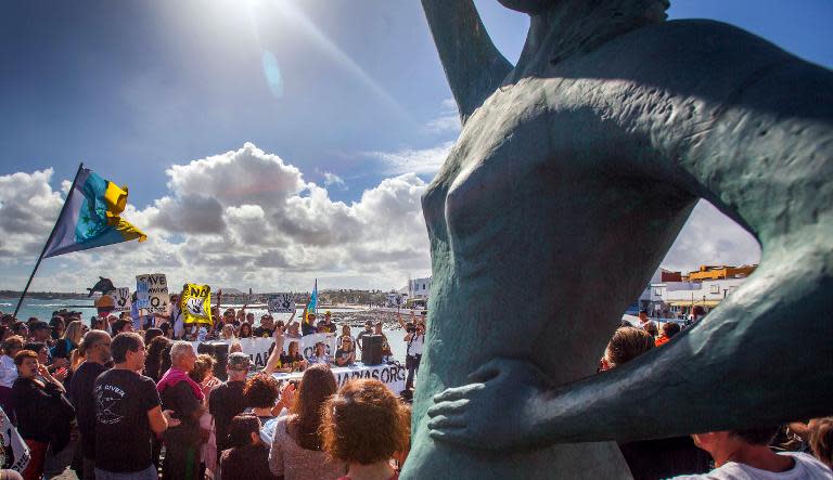 People take part in a protest against oil exploration off the coast of the Canary Islands, at a beach of Corralejo, on November 30, 2014