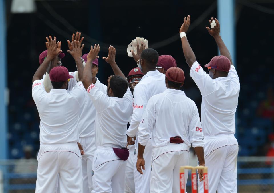 West Indies team celebrates the wicket o