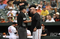 Baltimore Orioles manager Brandon Hyde, right, is ejected for arguing a replay ruling that overturned an out at home plate to a run scored by Pittsburgh Pirates' Greg Allen during the seventh inning of a baseball game, Sunday, Aug 7, 2022, in Baltimore. (AP Photo/Terrance Williams)