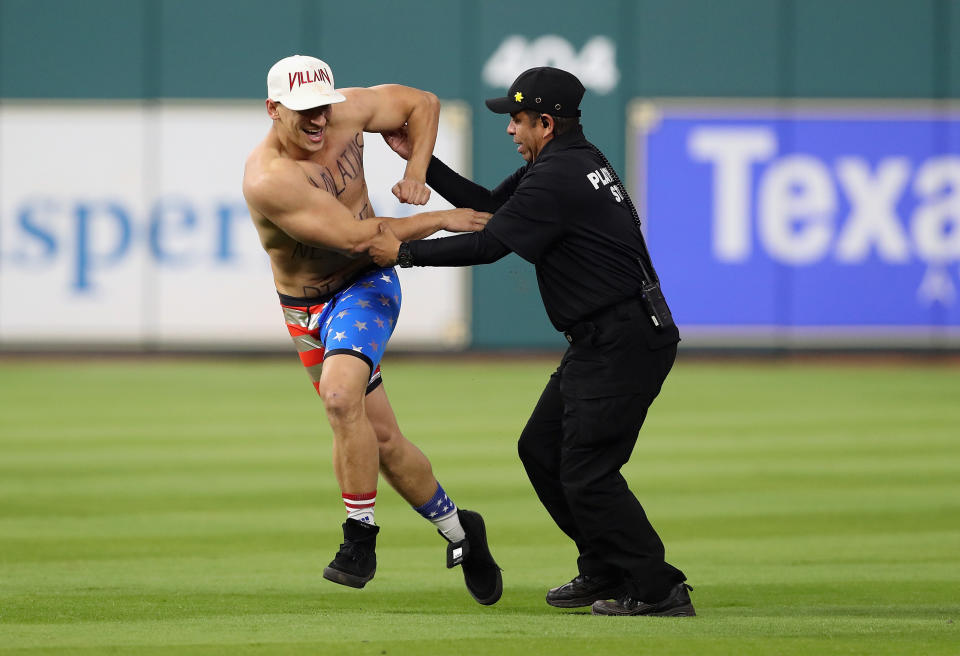 Security apprehends a man during Game 5&nbsp;of the 2017 World Series between the Houston Astros and the Los Angeles Dodgers on Oct. 29, 2017, in Houston, Texas. (Photo: Christian Petersen/Getty Images)