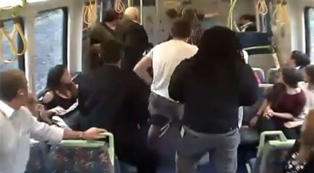 Passengers can be seen rushing to the woman's aid when Mr Smart grabbed her by the throat. Photo: 7 News