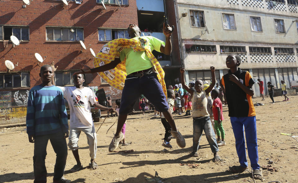 A supporter of Zimbabwe's President Emmerson Mnangagwa celebrates in Harare, Friday, Aug, 3, 2018. Mnangagwa won an election Friday with just over 50 percent of the ballots as the ruling party maintained control of the government in the first vote since the fall of longtime leader Robert Mugabe. (AP Photo/Tsvangirayi Mukwazhi)