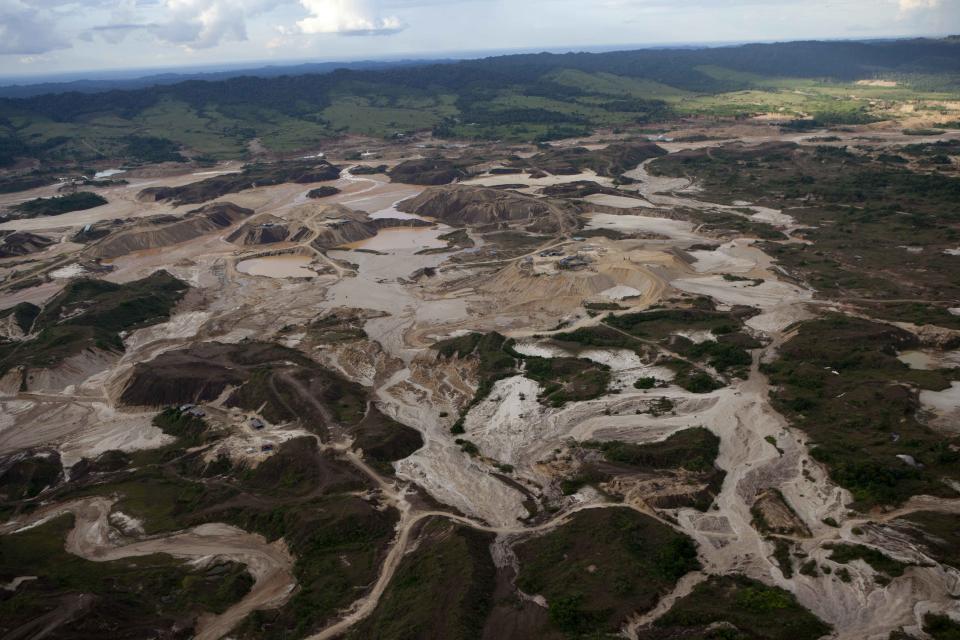 An aerial photo shows tailings in Huepetuhe district produced by informal mining in Peru's Madre de Dios region in Peru, Monday, April 28, 2014. Soldiers, police and marines have begun destroying illegal gold mining machinery in Peru’s southeastern jungle region of Madre de Dios. Illegal mining accounts for about 20 percent of Peru's gold exports, but most miners are poor migrants from the Andean highlands. (AP Photo/Rodrigo Abd)