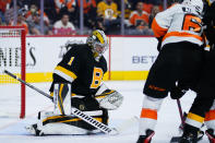 Boston Bruins' Jeremy Swayman, left, blocks a shot as Philadelphia Flyers' Nicolas Aube-Kubel looks on during the second period of an NHL hockey game, Wednesday, Oct. 20, 2021, in Philadelphia. (AP Photo/Matt Slocum)