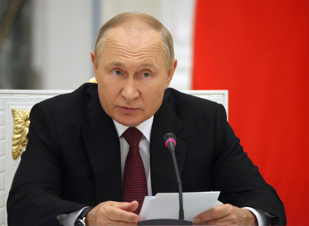 President Vladimir Putin at the microphone.