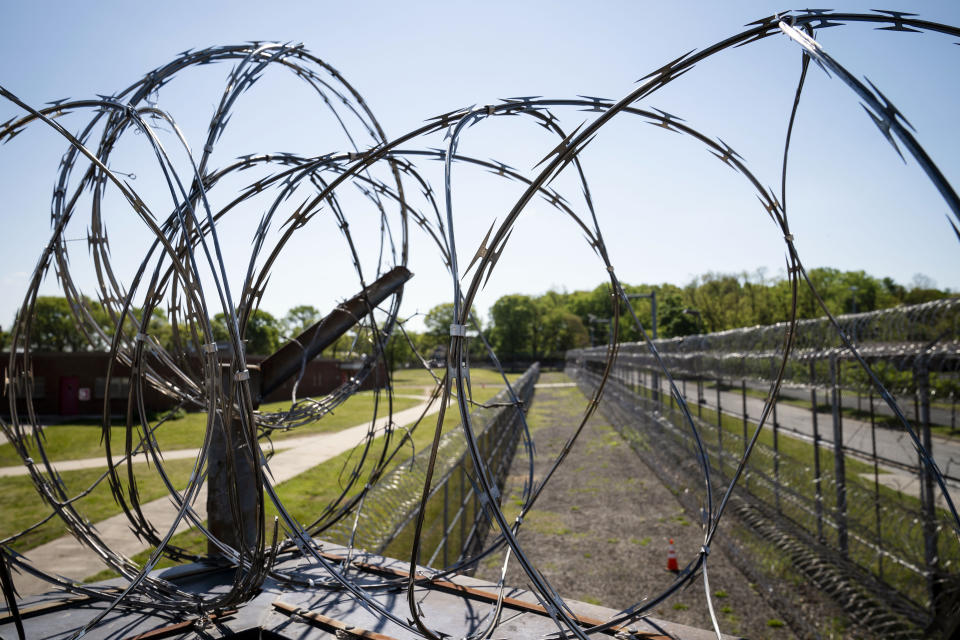 FILE — Razor wire surrounds the perimeter fencing at the former Arthur Kill Correctional Facility, May 11, 2021, in the Staten Island borough of New York. The New York Civil Liberties Union and Prisoners' Legal Services of New York filed a class-action lawsuit late Wednesday, April 5, 2023, in an Albany court claiming that the state routinely flouts limits on solitary confinement approved in 2021 by state lawmakers.(AP Photo/John Minchillo, File)