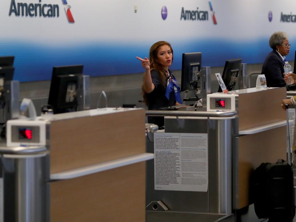 A passenger checks in for an American Airlines in Terminal D at Dallas/Fort Worth International Airport (DFW) on March 13, 2020 in Dallas, Texas.