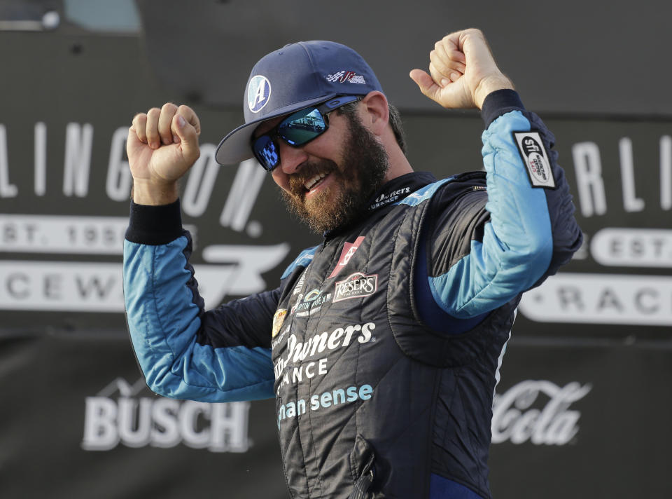 FILE - In this Sunday, May 9, 2021, file photo, Martin Truex Jr. celebrates in Victory Lane after winning the NASCAR Cup Series auto race at Darlington Raceway in Darlington, S.C. Truex starts on the pole at Dover a week after he took the checkered flag in a dominating drive at Darlington Raceway. (AP Photo/Terry Renna, File)