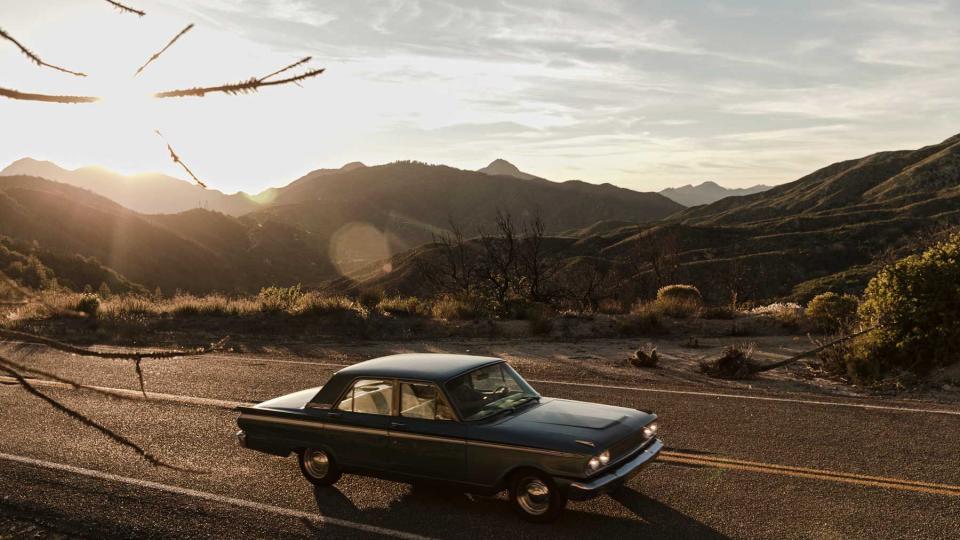 Vintage car on road trip in desert, Los Angeles, California