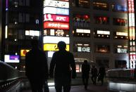 People walk on an overhead bridge near Sendai Station in Sendai, northern Japan December 17, 2013. (REUTERS/Issei Kato)