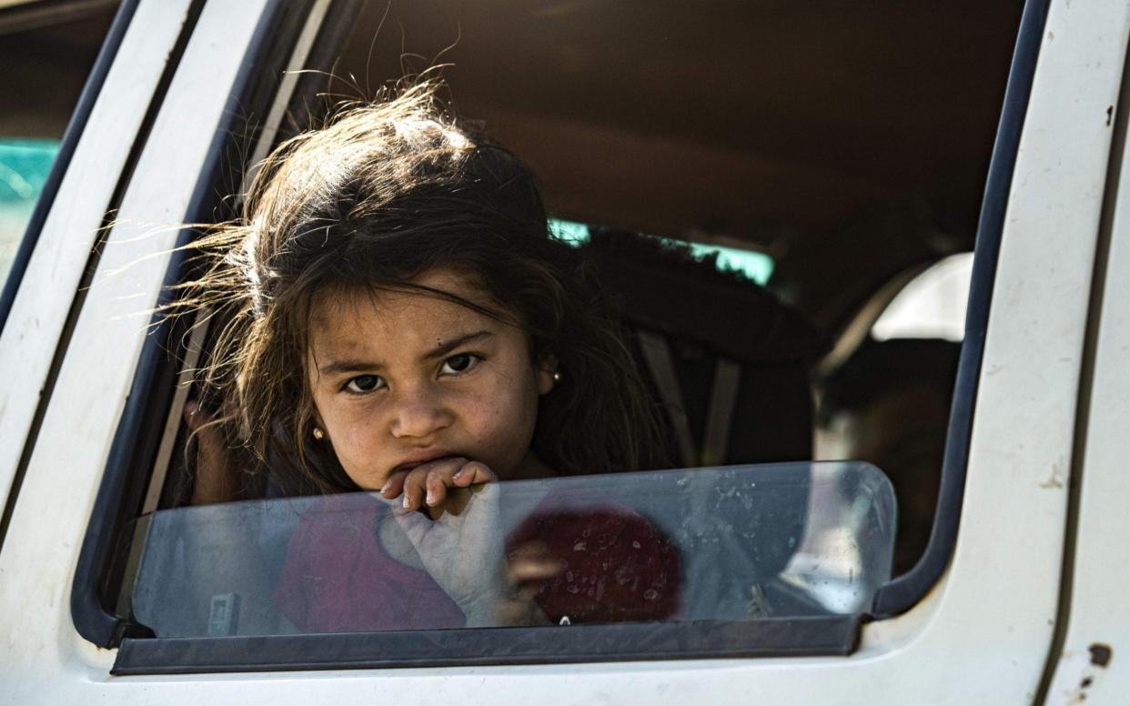  A young Syrian girl fleeing with her family from northern Syria - AFP
