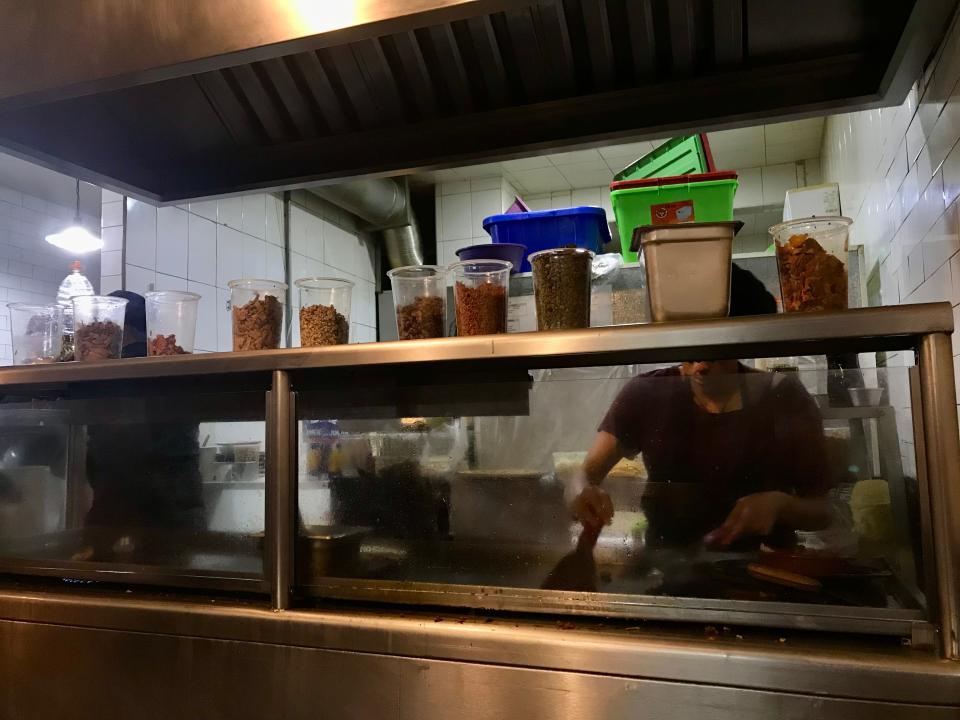 man behind kitchen counter cooking