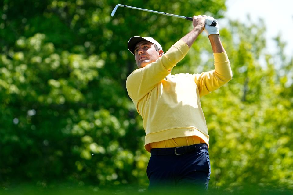 Scottie Scheffler tees off on the 15th hole during the first round of the PGA Championship golf tournament at Oak Hill Country Club.