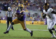 LSU running back Corey Kiner (21) runs past Central Michigan linebacker Kumehnnu Gwilly (33) for a touchdown during the fourth quarter of an NCAA college football game in Baton Rouge, La,. Saturday, Sept. 18, 2021. (AP Photo/Derick Hingle)