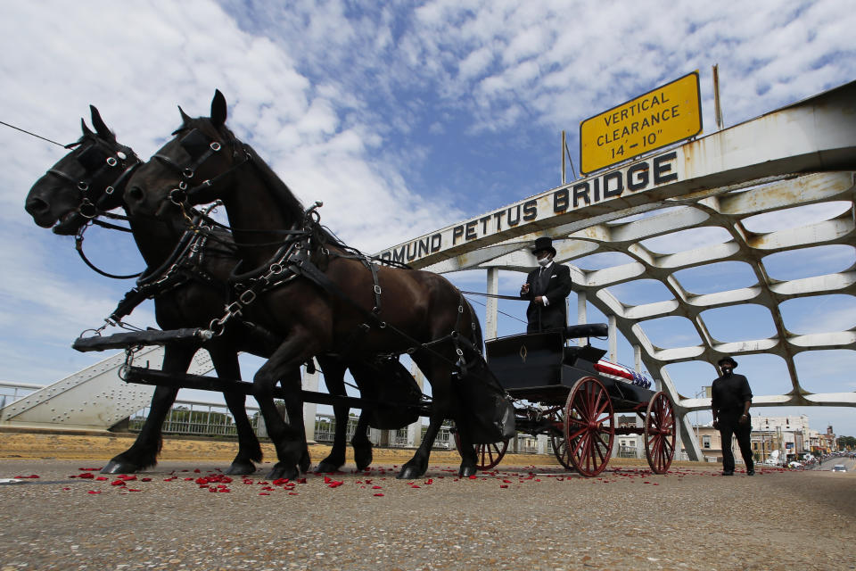 The casket of Rep. John Lewis moves over the Edmund Pettus Bridge by horse drawn carriage during a memorial service for Lewis, Sunday, July 26, 2020, in Selma, Ala. Lewis, who carried the struggle against racial discrimination from Southern battlegrounds of the 1960s to the halls of Congress, died Friday, July 17, 2020. (AP Photo/John Bazemore)