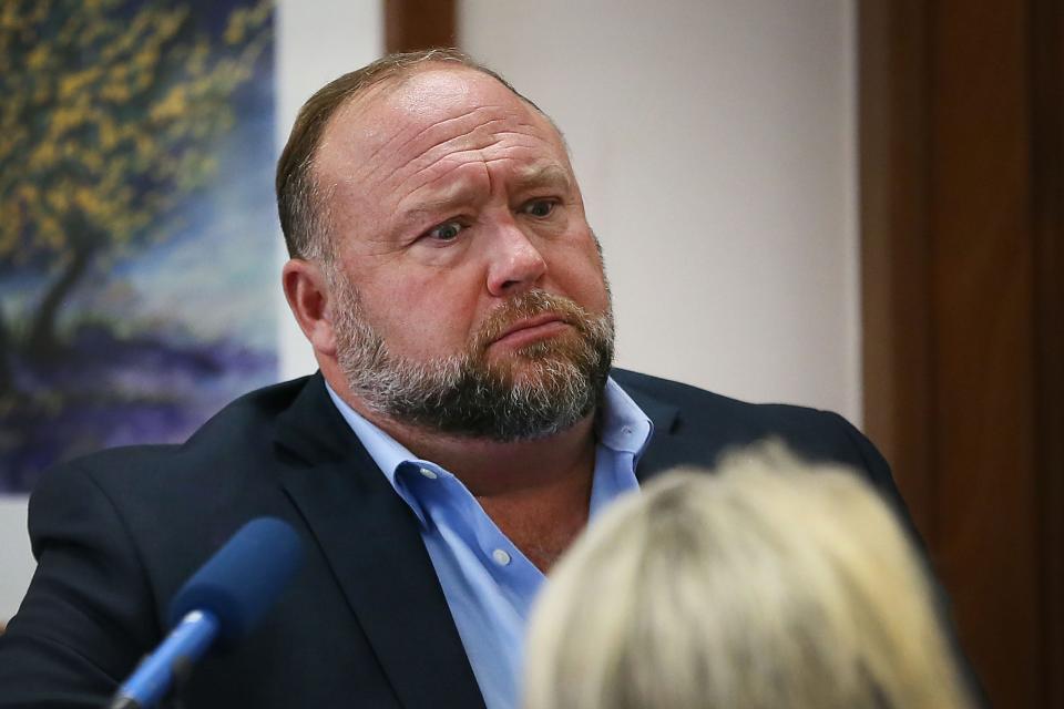 Alex Jones attempts to answer questions about his emails asked by Mark Bankston, lawyer for Neil Heslin and Scarlett Lewis, during trial at the Travis County Courthouse Wednesday Aug. 3, 2022. Jones has been found to have defamed the parents of a Sandy Hook student for calling the attack a hoax.