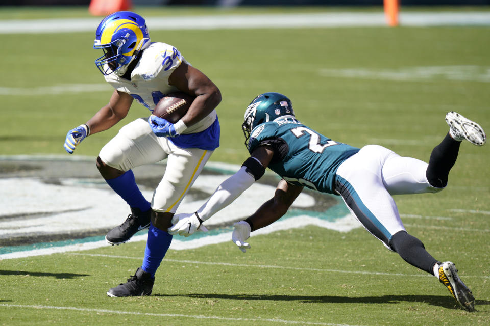 Los Angeles Rams' Malcolm Brown (34) runs past Philadelphia Eagles' Rodney McLeod (23) during the first half of an NFL football game, Sunday, Sept. 20, 2020, in Philadelphia. (AP Photo/Chris Szagola)