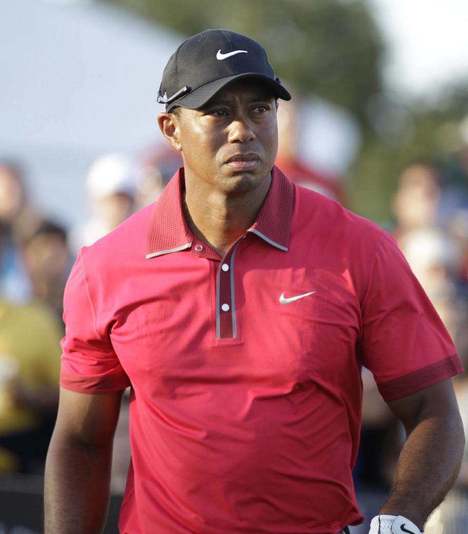 Tiger Woods leaves the 17th hole after putting during the final round of the Cadillac Championship golf tournament Sunday, March 9, 2014, in Doral, Fla. (AP Photo/Luis M. Alvarez)