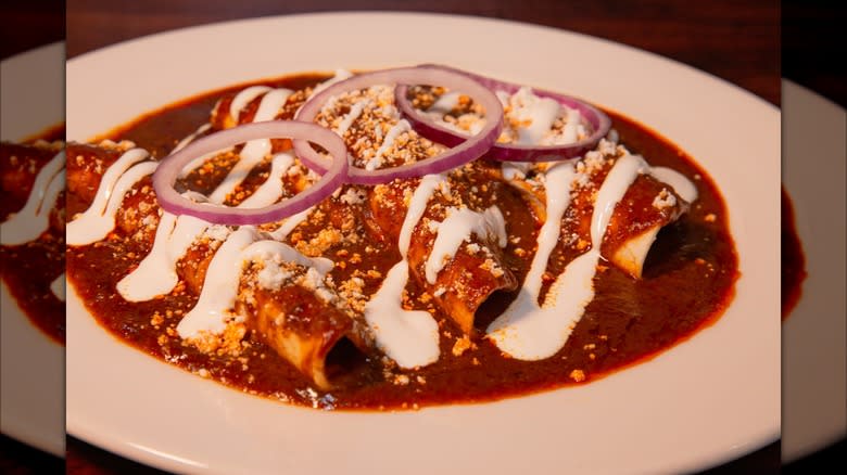 Plated enchiladas with red sauce
