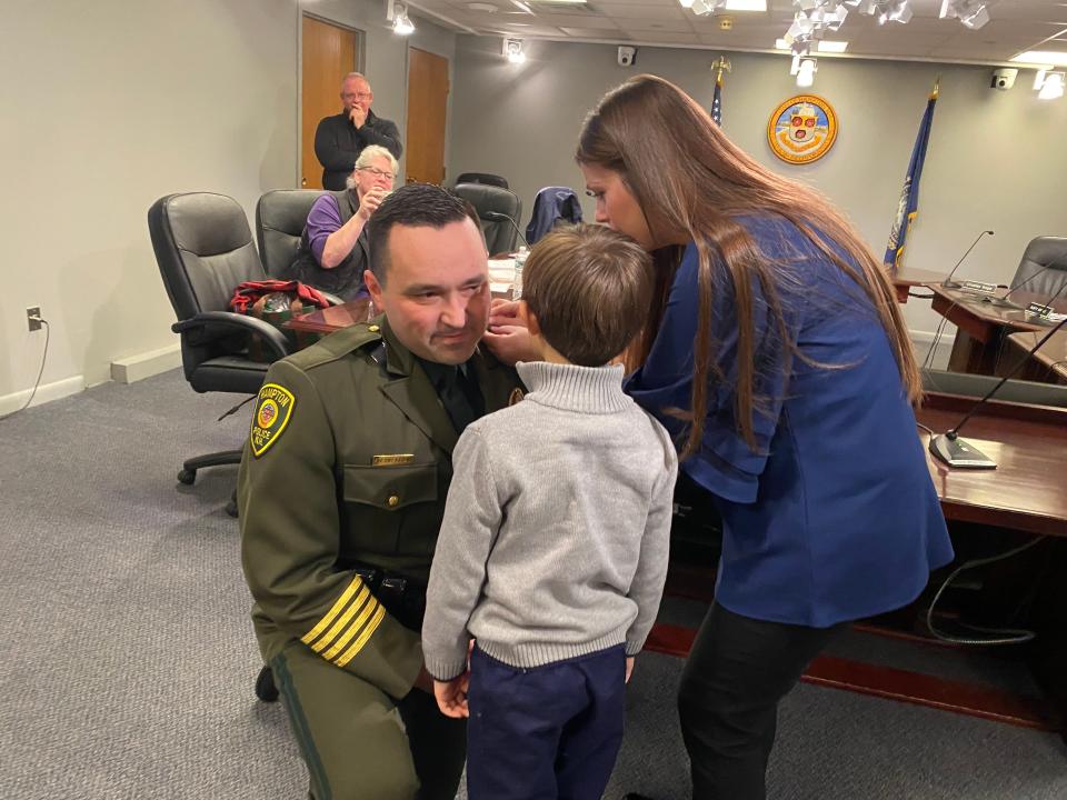 Alex Reno is sworn in as chief of the Hampton Police Department Monday, Dec. 19, 2022, with his wife Kimberley and son Nicholas.