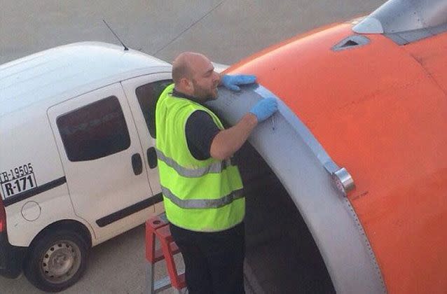 In May 2015, a passenger took this picture from inside an EasyJet plane of a worker using tape to repair the engine section. Source: Reddit