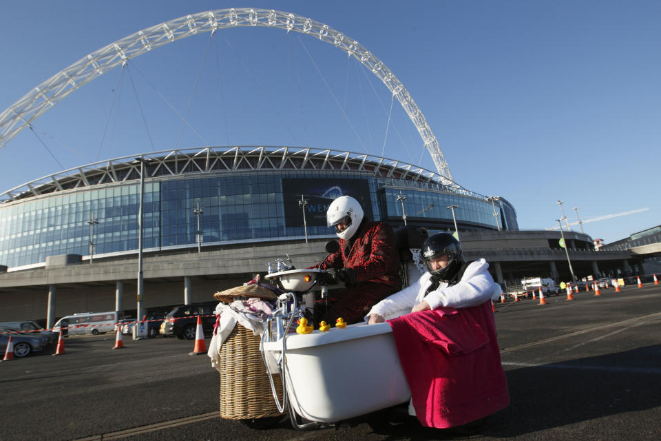 Former England cricketer Andrew "Freddie" Flintoff (R) sits in a bath-tub sidecar with British inventor Edd China (L) at the controls as they try to break the fastest toilet world record at Wembley Stadium in London on March 19, 2012. Flintoff was attempting to set twelve Guinness World Records in 12 hours to raise money for the Sport Relief charity. AFP PHOTO / JUSTIN TALLIS (Photo credit should read JUSTIN TALLIS/AFP/Getty Images)