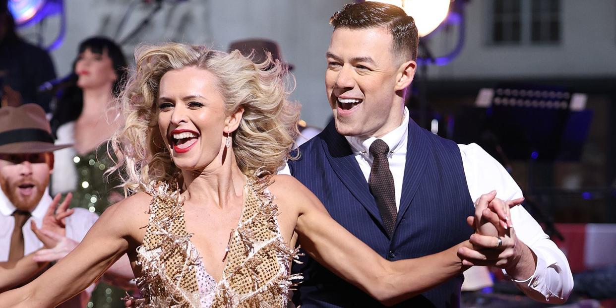 nadiya bychkova and kai widdrington dancing on a stage