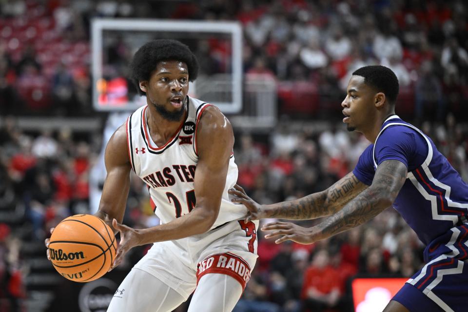 Texas Tech guard Kerwin Walton, left, tries to pass the ball around TCU guard Avery Anderson III during the first half of an NCAA college basketball game Tuesday, Feb. 20, 2024, in Lubbock, Texas. (AP Photo/Justin Rex)