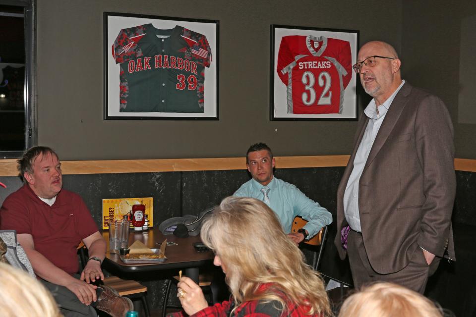 Sandusky County Republican Party Chairman Justin Smith, left, listens to state Rep. Gary Click at an informational meeting concerning the possible veto override of HB68, held at Buffalo Wild Wings in Fremont.