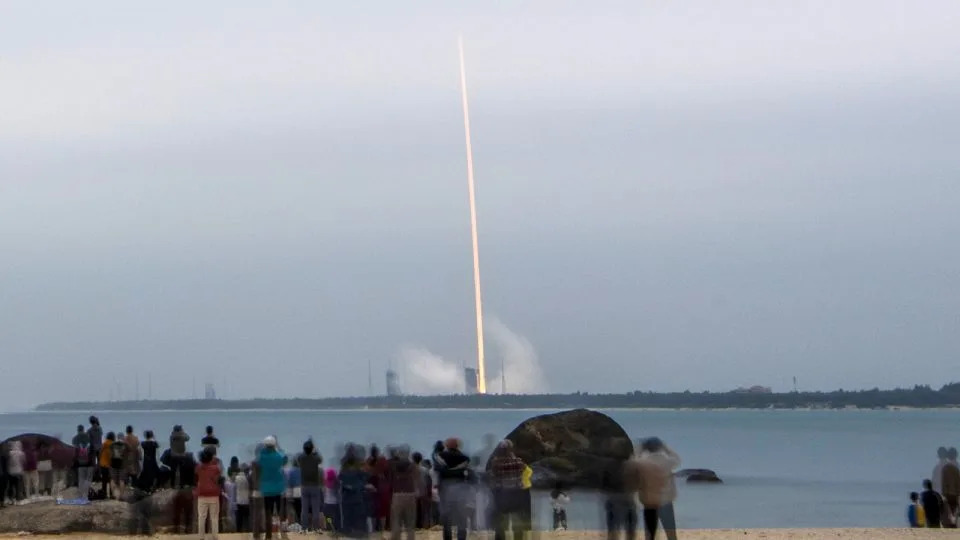 Spectators watch a rocket carrying the relay satellite Queqiao-2 blast off from the Wenchang Spacecraft Launch Site on March 20, 2024. - Luo Yunfei/China News Service/VCG/Getty Images)