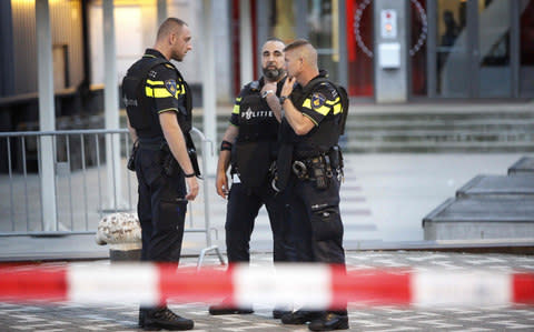 Police stand during the evacuation the Maassilo concert venue after a concert by Californian ban Allah-Las was canceled in relation to a terror attack threat, according to police and the venue, on August 23, 2017, in Rotterdam - Credit: AFP