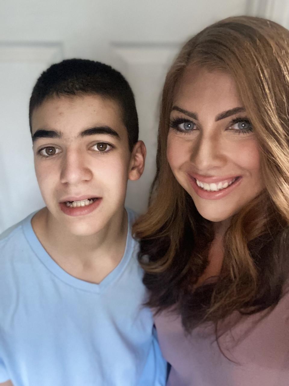 Brayden Gomes, left, 14, along with his mother Teresa Gomes of Taunton. Teresa Gomes said Project Lifesaver bracelet is always secure on her son, who has autism.