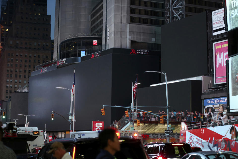 Screens in Times Square are black during a widespread power outage, Saturday, July 13, 2019, in New York. Authorities say a transformer fire caused a power outage in Manhattan and left businesses without electricity, elevators stuck and subway cars stalled. (AP Photo/Michael Owens)