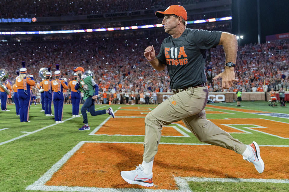 Clemson coach Dabo Swinney runs onto the field at the start of the team's NCAA college football game against Louisiana Tech on Saturday, Sept. 17, 2022, in Clemson, S.C. (AP Photo/Jacob Kupferman)