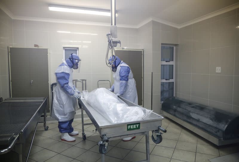 FILE PHOTO: Members of the Muslim burial organization prepare the body of a man who died due to the coronavirus disease (COVID-19) for burial at Ghiedmatiel Islamia mosque in Cape Town