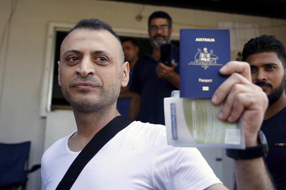 Australian-Lebanese dual citizen Amer Khayyat shows his Australian passport to journalists, after his release from prison in Roumieh, east of Beirut, Lebanon, Friday, Sept. 20, 2019. Lebanese authorities have released the Lebanese-Australian who had been detained in Lebanon for more than two years after he was found innocent in an alleged plot to bring down a passenger plane bound for the United Arab Emirates from Sydney. (AP Photo/Bilal Hussein)