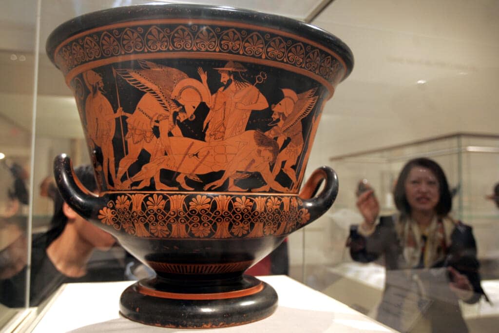 IMAGE DOES NOT DEPICT LOOTED ITEMS DESCRIBED IN STORY. Helena Park, a Metropolitan Museum of Art voulunteer, explains the Euphronios Krater, a 2,500-year-old Greek vase, during a Korean language tour of the museum’s collection, Tuesday, Feb. 21, 2006 in New York. (AP Photo/Mary Altaffer)