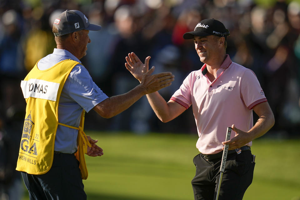 Justin Thomas celebrates with caddie Jim "Bones" Mackay after winning the PGA Championship golf tournament in a playoff against Will Zalatoris at Southern Hills Country Club, Sunday, May 22, 2022, in Tulsa, Okla. (AP Photo/Sue Ogrocki)