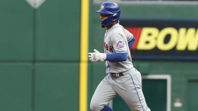 New York Mets Shortstop Francisco Lindor turns a double play on a