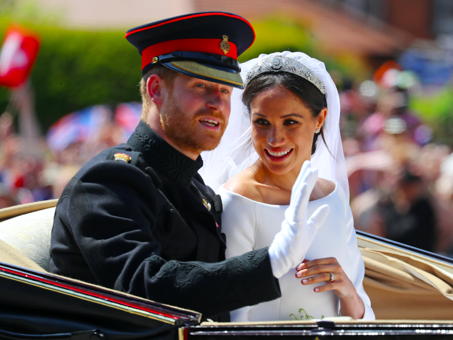 <em>The couple waved to crowds in a procession following their wedding (Rex)</em>