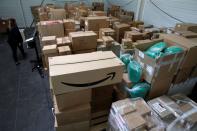 An employee prepares an order for Amazon at Porona warehouse in Bruay-sur-l'Escaut